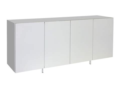 A White Cabinet With Three Doors And Two Legs On The Side Against A