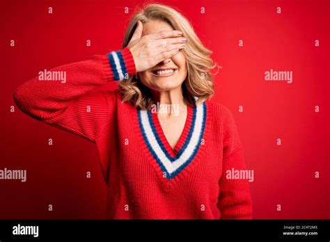 Middle Age Beautiful Blonde Woman Wearing Casual Sweater Over Isolated Red Background Smiling