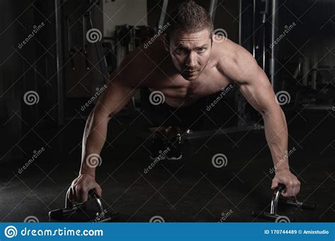 Portrait Of Muscular Strong Athletic Man With Naked Torso Pumping Up Muscles Doing Push Up In