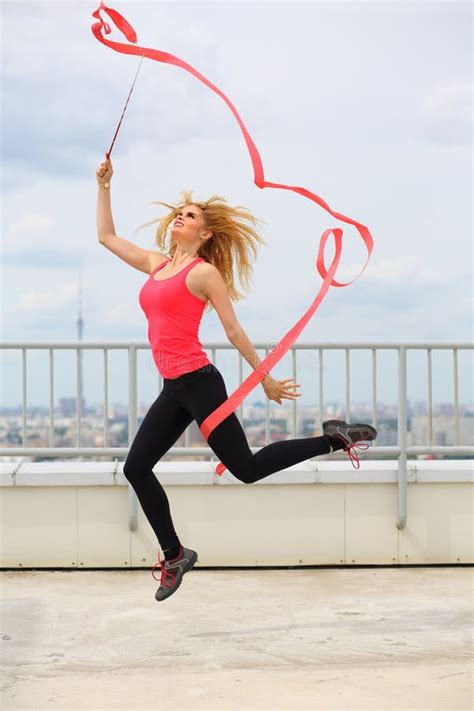 Beautiful Blonde Jumping With Red Curly Ribbon On Stock Photo Image Of Hand Cloudiness