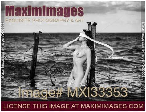Photo Of Woman Standing Naked In Water Against A Rusty Post With A Blindfold Fine Art Nude Black