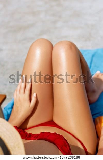 Sexy Suntan Bikini Woman Legs Relaxing Stock Photo