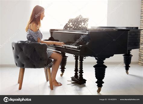 Woman Playing Piano Home Stock Photo by ©belchonock 191402974