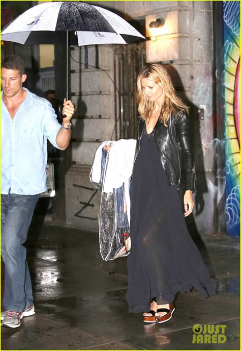 Heidi Klum Is Practically Naked Under A Shield Of Hangers For Project Runway Poster Photo