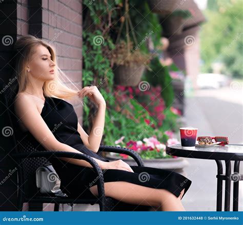 Blonde Girl Sitting At A Table In A Cafe Stock Photo Image Of Outdoor Blonde