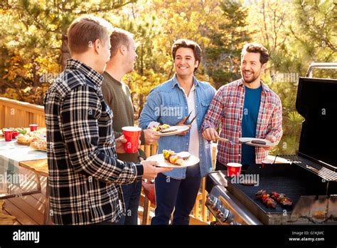 Group Of Gay Male Friends Enjoying Barbeque Together Stock Photo Alamy