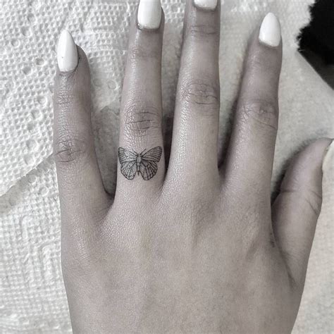 Butterfly tattoo on the ring finger. | Small tattoos, Ring finger ...