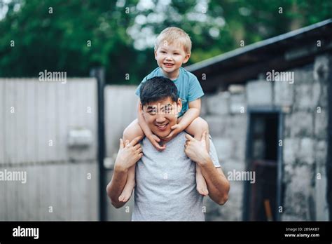 Blonde Three Years Old Boy Sitting On Father S Shoulders Kazakh Father And Caucasian Mother