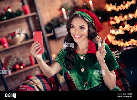 Photo Of Funny Millennial Brunette Lady Do Selfie Show V Sign Wear Green Costume At Home On