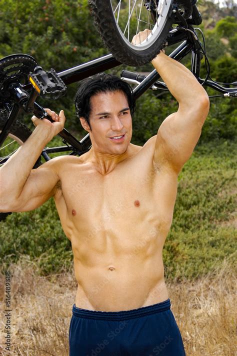 Hot Handsome Bicycler Lifts His Bike Above His Head And Showing His