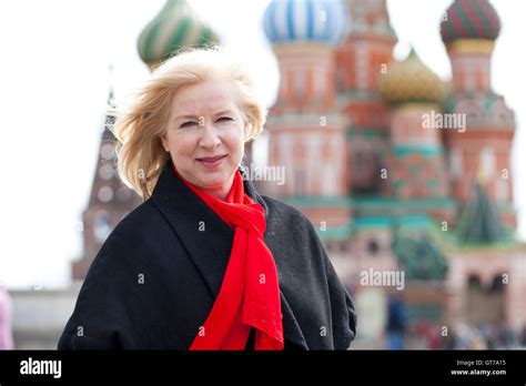 Happy Portrait Of An Elderly Blonde Woman Against The Background Of The Red Square Moscow