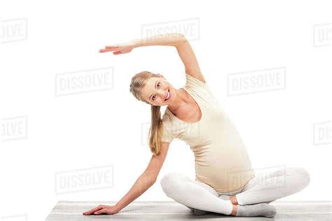 Pregnant Blonde Woman Stretching And Smiling Isolated On White Stock Photo Dissolve