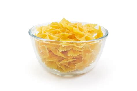 Uncooked Bow Tie Pasta In Glass Bowl On White Background Stock Image