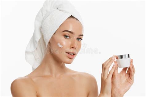 Close Up Beauty Portrait Of A Smiling Beautiful Half Naked Woman Applying Face Cream Isolated