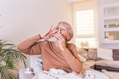 Senior Woman Is Having Allergies And She Is Using Nasal Spray To Help