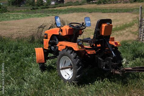 Tractor On The Field The Orange Minitractor Works In The Field