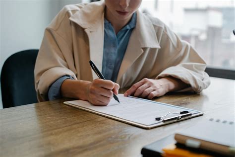 focused woman writing  clipboard  hiring candidate  stock