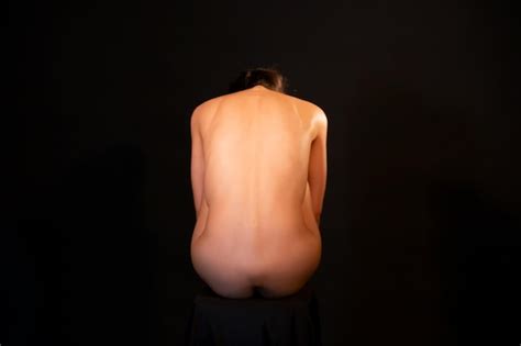 Premium Photo Rear View Of Naked Woman Against Black Background