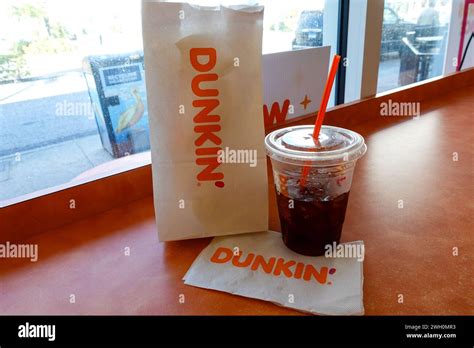 Dunkin Donuts Paper Bag And Iced Coffee Inside The Shop Stock Photo