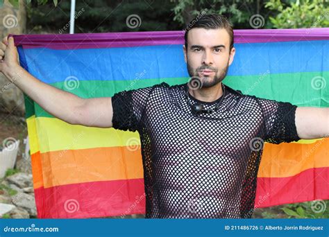 Very Cute Gay Man Holding The Rainbow Flag Stock Photo Image Of