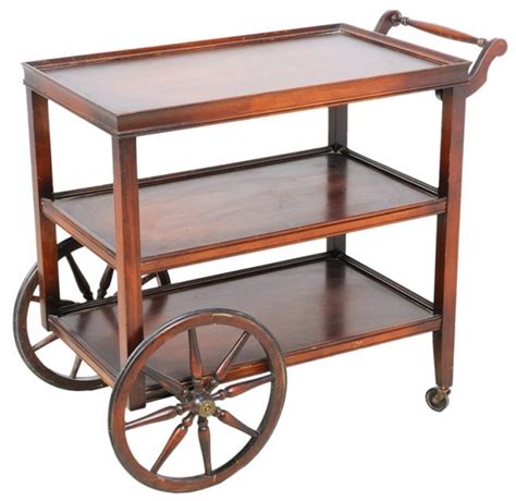 A Vintage Rolling Serving Cart With Wagon Wheels Lot 124