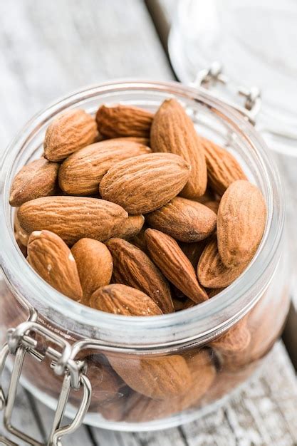 Premium Photo Dried Almond Nuts In Jar Unpeeled Almonds