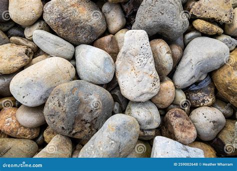 Pile Of Sedimentary Pebbles And Rocks On A River Bed Stock Photo