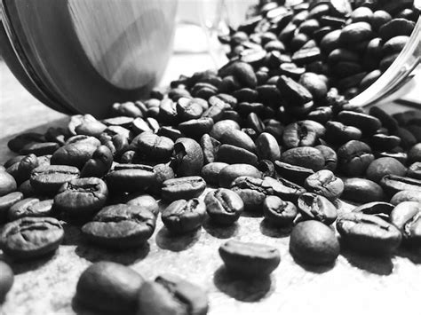 Premium Photo Close Up Of Roasted Coffee Beans On Table