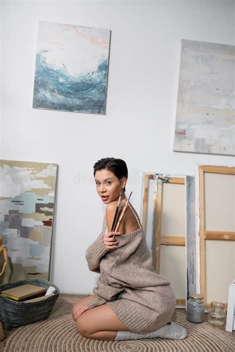 Seductive Brunette Artist Holding Paintbrushes While Stock Photo Image Of Caucasian Indoors