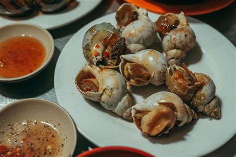 close   cooked sea snails  dipping sauce  stock photo