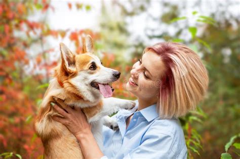 Portrait of a Woman Who Holds Her Beloved Pembroke Welsh Corgi Dog ...