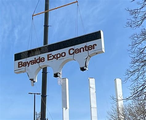 Crane Operators Remove Top Part Of Dilapidated Bayside Expo Sign