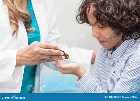 Doctor Giving a Child Homeopathic Medicine Stock Image - Image of healthcare, cure: 143202259