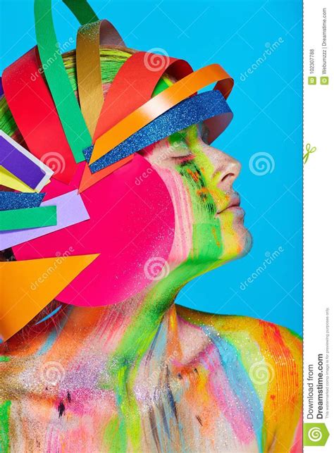 Model With Colorful Abstract Makeup In Multicolored Helmet Stock Photo