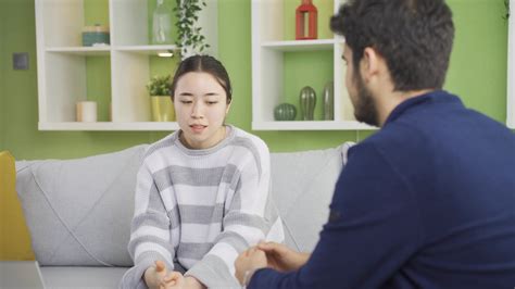 Remorseful young asian woman feeling guilty. Young woman talking to her