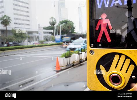 Wait Signal Sign Located At Pedestrian Crosswalk Area On A Busy City