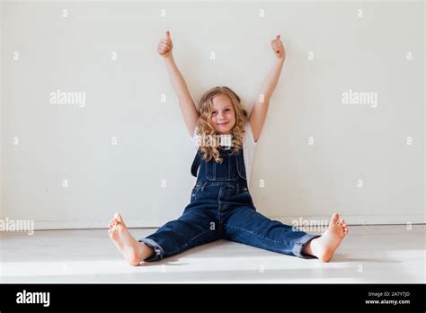 Portrait Of A Beautiful Blonde Girl In A Denim Jumpsuit Stock Photo Alamy