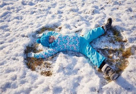 Girl making snow angels — Stock Photo © mavoimages #98529102