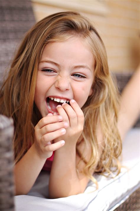 Portrait Of Laughing Girl On The Couch Free Image Download