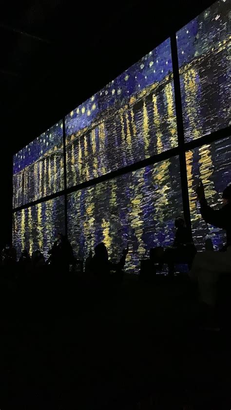 People Are Standing In Front Of A Large Screen With Starr Lights On It