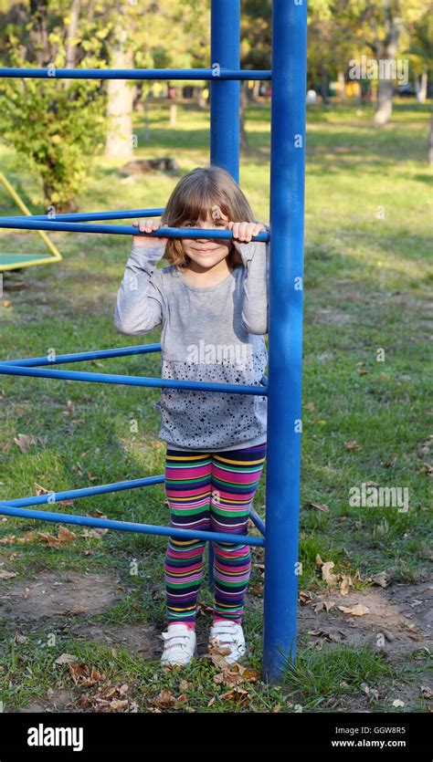 little girl hiding on playground Stock Photo - Alamy