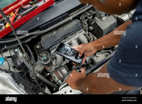 Overhead View Of Man Taking Photograph Of Car Engine Stock Photo Alamy