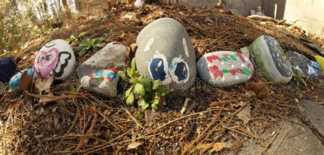 Close Up Of Novelty Colorful Painted Rocks In Children S Rock Garden