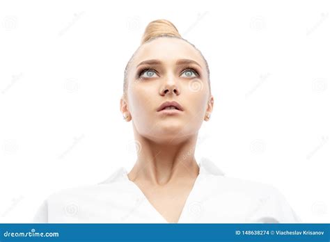 Beautiful Spectacular Blonde Lady With An Unusual High Hairdo With Big Blue Eyes On A White