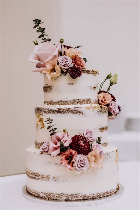Buttercream Semi Naked Wedding Cake With Gold Leaf And Fresh Flowers