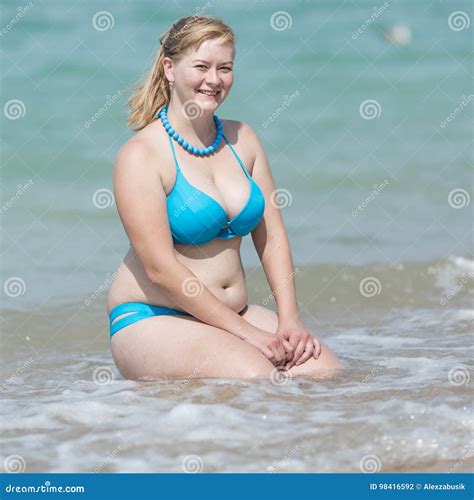 Adult Woman In Bikini Sitting In Water Hands On Knees Stock Photo Image Of Beach Hands
