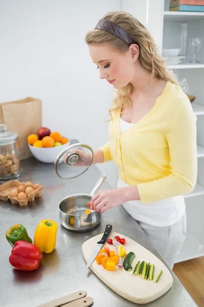 Premium Photo Content Cute Blonde Looking At Pot