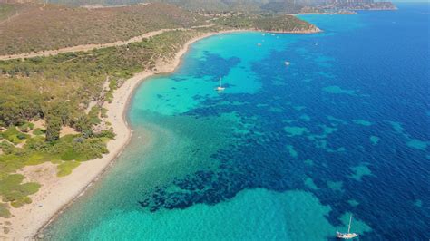 Aerial shot of a beautiful island with calm, clear water near coral
