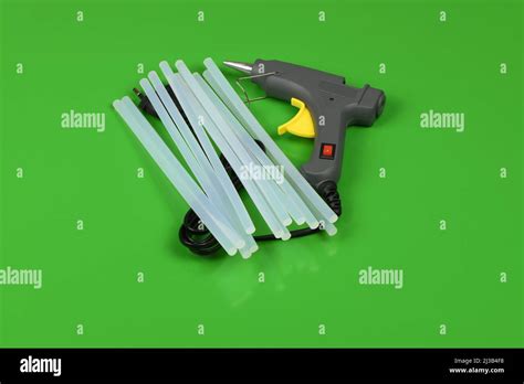 Electric Hot Glue Gun With Gluestick Isolated On Green Background High Resolution Photo Full