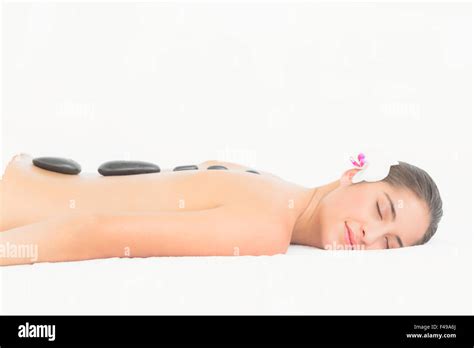 Pretty Brunette Enjoying A Hot Stone Massage Stock Photo Alamy